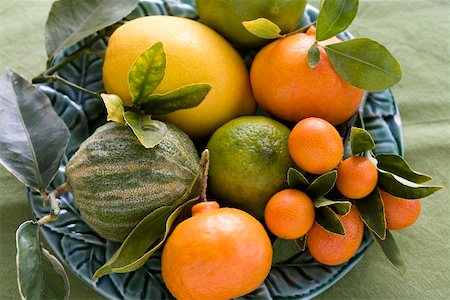 Assorted citrus fruit with leaves Stock Photo - Premium Royalty-Free, Code: 659-02211378