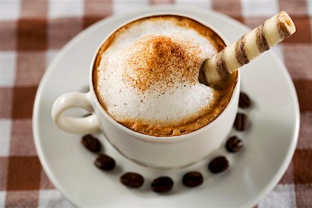 simsearch:659-01852558,k - A cup of cappuccino with wafer rolls and coffee beans Stock Photo - Premium Royalty-Free, Code: 659-02211387