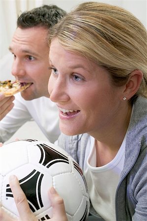 eating pizza, sports - Young couple watching TV with football and pizza Stock Photo - Premium Royalty-Free, Code: 659-02211475