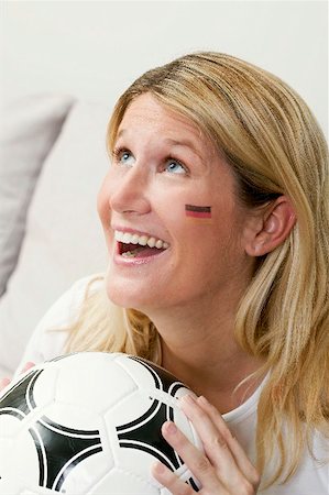 simsearch:659-02211458,k - Young woman with German colours on her face holding football Foto de stock - Sin royalties Premium, Código: 659-02211484