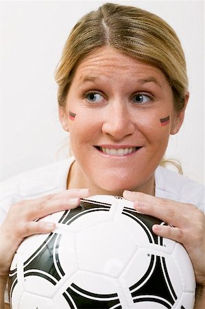 simsearch:659-02211458,k - Young woman with German colours on her face holding football Foto de stock - Sin royalties Premium, Código: 659-02211482