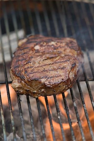 steak bbq flame - Beef steak on a barbecue Stock Photo - Premium Royalty-Free, Code: 659-02211955