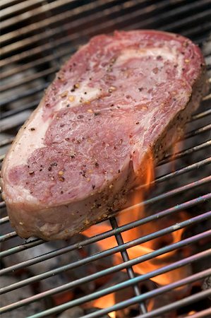 steak bbq flame - Raw beef steak on a barbecue Stock Photo - Premium Royalty-Free, Code: 659-02211951