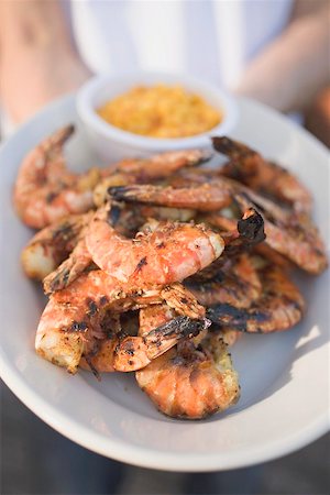 simsearch:659-01844703,k - Person holding plate of grilled shrimps Stock Photo - Premium Royalty-Free, Code: 659-02212008