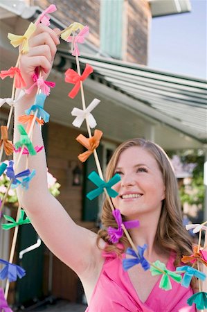 decoration barbecue party - Woman with coloured garlands for garden party Stock Photo - Premium Royalty-Free, Code: 659-02212011