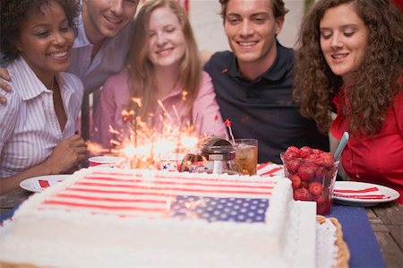 summer party adults - Young people behind cake with sparklers (4th of July, USA) Stock Photo - Premium Royalty-Free, Code: 659-02212117