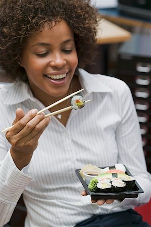 people eating at work - Woman eating sushi in office Stock Photo - Premium Royalty-Free, Code: 659-02212375