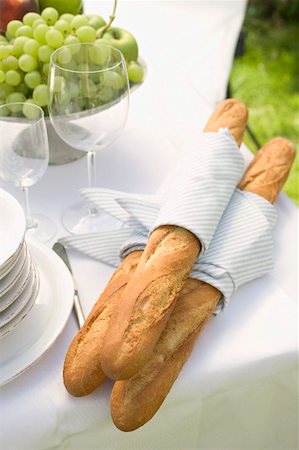 french breads - Baguettes, wine glasses and fruit on table out of doors Stock Photo - Premium Royalty-Free, Code: 659-02212592