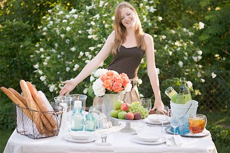 simsearch:659-02212589,k - Woman presenting table laid in garden Stock Photo - Premium Royalty-Free, Code: 659-02212610