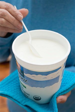 plastic tumbler - Woman eating yoghurt out of pot Stock Photo - Premium Royalty-Free, Code: 659-02212755