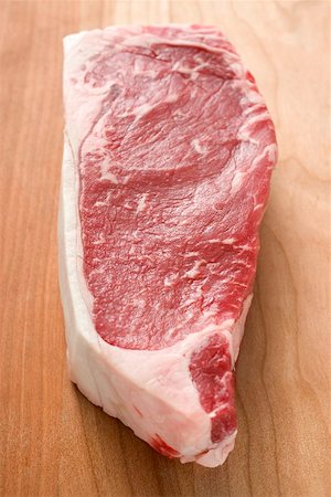 Beef steak on wooden background Stock Photo - Premium Royalty-Free, Code: 659-02212791