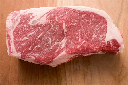 steak chunk - Beef steak on wooden background Stock Photo - Premium Royalty-Free, Code: 659-02212792