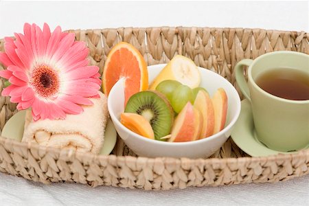 Cup of tea, fresh fruit, towel and flower in basket Stock Photo - Premium Royalty-Free, Code: 659-02212824