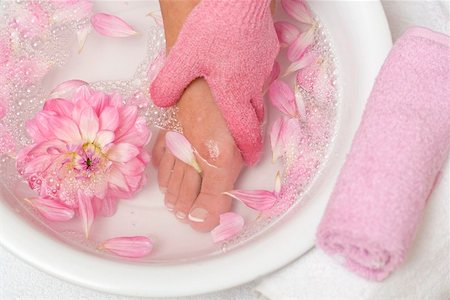 Woman washing her foot with pink peeling glove Stock Photo - Premium Royalty-Free, Code: 659-02212830