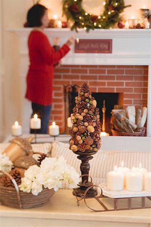 simsearch:659-02212893,k - Woman by fireplace in living room decorated for Christmas Stock Photo - Premium Royalty-Free, Code: 659-02212881