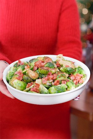 simsearch:659-02212906,k - Woman holding dish of Brussels sprouts with bacon Stock Photo - Premium Royalty-Free, Code: 659-02212899