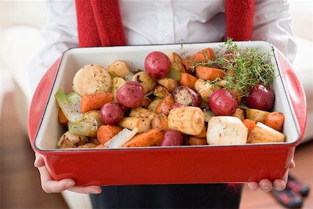 simsearch:659-02212906,k - Woman holding roasting dish full of roasted root vegetables Stock Photo - Premium Royalty-Free, Code: 659-02212908