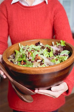 Woman holding large bowl of salad leaves with nuts Stock Photo - Premium Royalty-Free, Code: 659-02212901