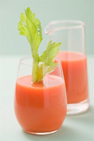 Glass of carrot juice with celery jug in background Stock Photo - Premium Royalty-Free, Code: 659-02213024