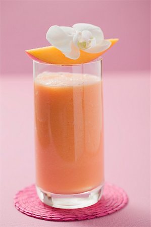 simsearch:659-03526783,k - Glass of mango smoothie with wedge of mango and orchid Stock Photo - Premium Royalty-Free, Code: 659-02213026