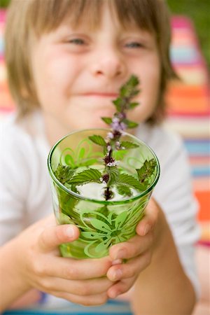 Small boy holding glass of cold peppermint tea Stock Photo - Premium Royalty-Free, Code: 659-02213067