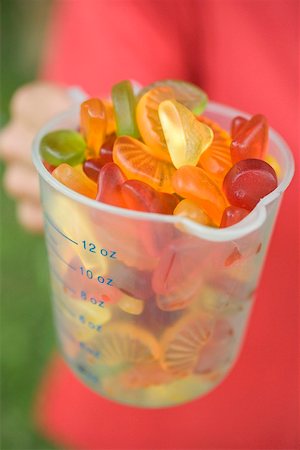 Hands holding measuring jug full of jelly sweets Foto de stock - Sin royalties Premium, Código: 659-02213081