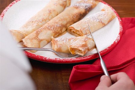 Woman eating pancakes filled with apricot jam Stock Photo - Premium Royalty-Free, Code: 659-02213108