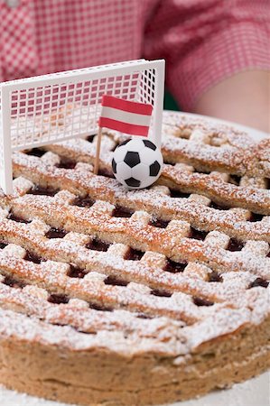 Woman holding Linzer torte with football, goal & Austrian flag Stock Photo - Premium Royalty-Free, Code: 659-02213102