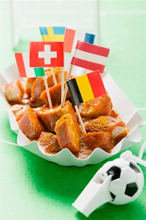 Currywurst with various flags in paper dish Stock Photo - Premium Royalty-Free, Code: 659-02213195