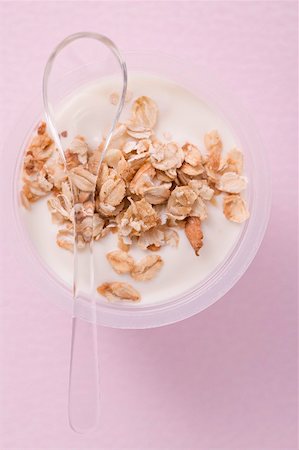 Yoghurt with cereal in plastic pot with spoon Stock Photo - Premium Royalty-Free, Code: 659-02213319