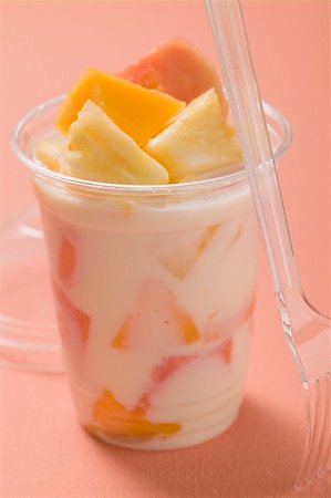 simsearch:659-02212753,k - Yoghurt with fresh fruit in plastic pot, fork beside it Stock Photo - Premium Royalty-Free, Code: 659-02213334