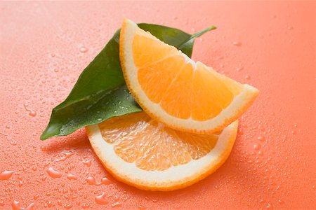 Orange wedge, orange slice and leaf with drops of water Stock Photo - Premium Royalty-Free, Code: 659-02213441