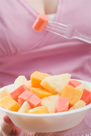 simsearch:659-02213327,k - Woman eating exotic fruit salad Foto de stock - Sin royalties Premium, Código: 659-02213549