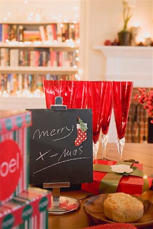 Xmas decorations & glasses on dining table in front of fireplace Stock Photo - Premium Royalty-Free, Code: 659-02213779