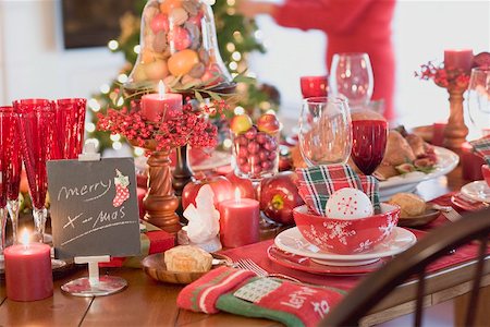 Christmas table, woman in background (USA) Stock Photo - Premium Royalty-Free, Code: 659-02213847