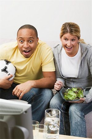 simsearch:659-03524452,k - Couple en face de la TV avec le football et salade Photographie de stock - Premium Libres de Droits, Code: 659-02213856