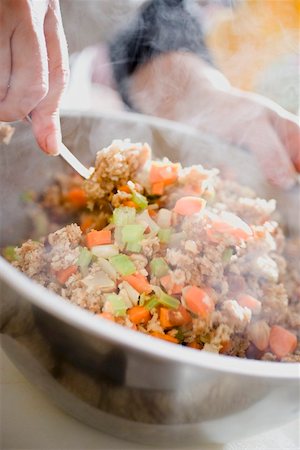 Making bread stuffing: folding in vegetables Stock Photo - Premium Royalty-Free, Code: 659-02213967