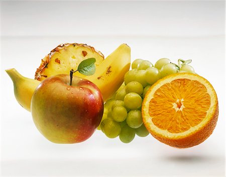 simsearch:659-03536778,k - Fruit still life: apple, banana, grapes, pineapple, orange Stock Photo - Premium Royalty-Free, Code: 659-03524150