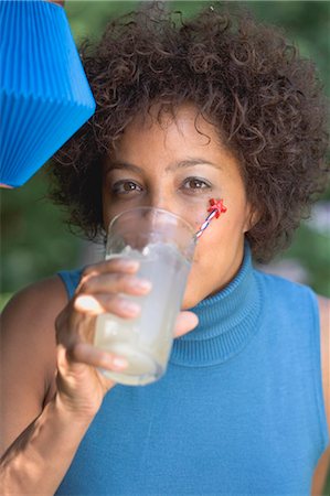 Woman drinking lemonade at a garden party Stock Photo - Premium Royalty-Free, Code: 659-03524282