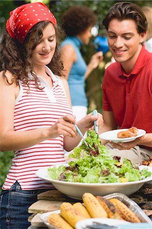 Jeune femme au service de salade verte à un barbecue Photographie de stock - Premium Libres de Droits, Code: 659-03524300