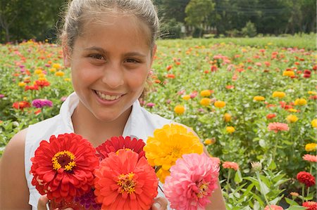 summer flower bouquet - Girl with summer flowers in front of a field of flowers Stock Photo - Premium Royalty-Free, Code: 659-03524385