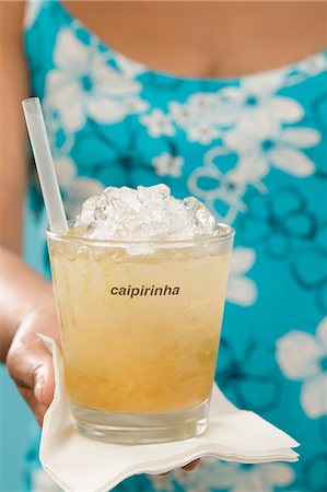 Woman holding cocktail in glass with the word 'Caipirinha' Stock Photo - Premium Royalty-Free, Code: 659-03524390