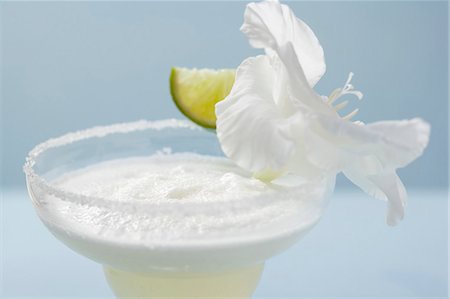 simsearch:659-03524397,k - Margarita in a glass with a salted rim, lime & white orchid Stock Photo - Premium Royalty-Free, Code: 659-03524409