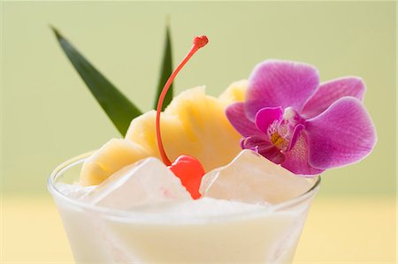 Piña Colada with pineapple, cocktail cherry and orchid Stock Photo - Premium Royalty-Free, Code: 659-03524402