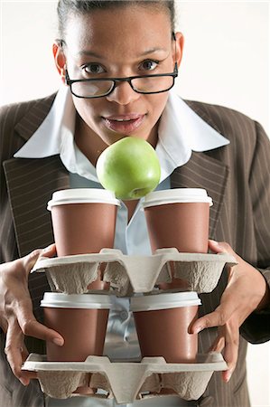 pile hands bussiness - Businesswoman holding four cups of coffee and an apple Stock Photo - Premium Royalty-Free, Code: 659-03524559