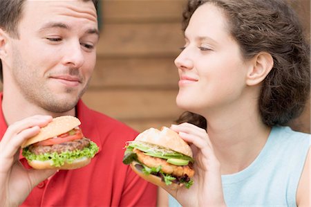 enquiring - Couple with two different burgers Stock Photo - Premium Royalty-Free, Code: 659-03524565