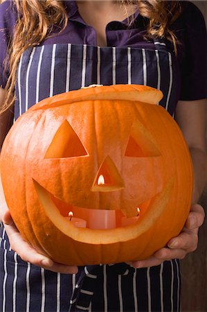 Woman holding pumpkin lantern for Halloween Stock Photo - Premium Royalty-Free, Code: 659-03524642