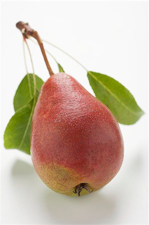 single pear - Red pear with stalk and leaves Stock Photo - Premium Royalty-Free, Code: 659-03524660