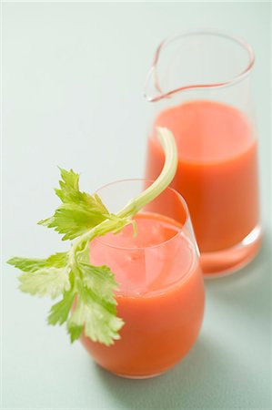 Glass of carrot juice with celery, jug in background Stock Photo - Premium Royalty-Free, Code: 659-03524663