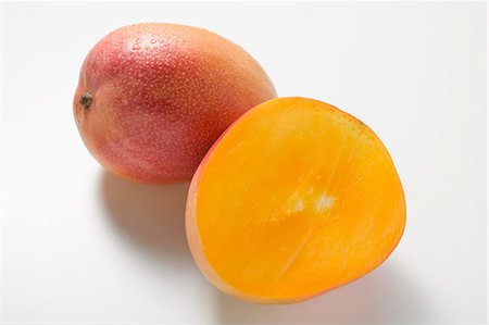 Whole mango and half a mango Stock Photo - Premium Royalty-Free, Code: 659-03524922